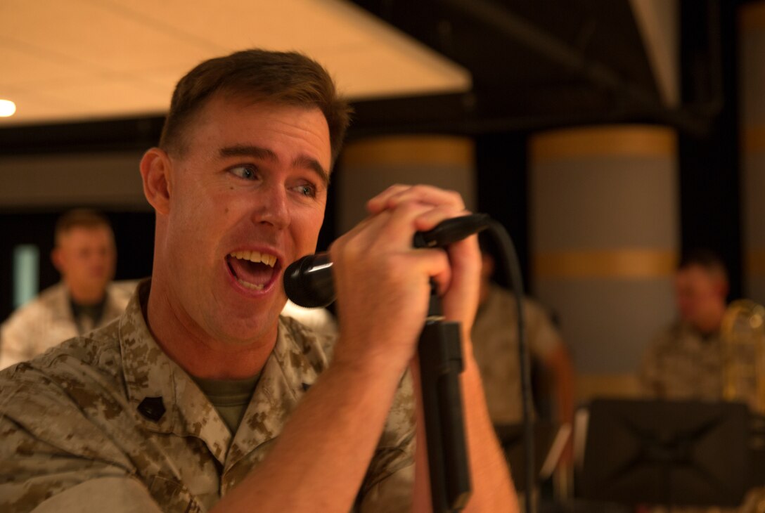 Gunnery Sgt. Adam Pezdek, small ensemble leader and vocalist with the 3rd Marine Aircraft Wing Rock Band, sings “Enjoy the Silence,” by Depeche Mode, during rehearsal aboard Marine Corps Air Station Miramar, Calif., July 16. The entire band is slated to perform at Marine Week Seattle, scheduled for July 26 - Aug. 3. 