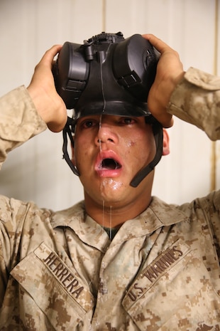Recruit Fidel Herrera Jr., Platoon 3203, feels the effects of chlorobenzylidene malonitrile, or CS Gas during the Confidence Chamber at Edson Range aboard Marine Corps Base Camp Pendleton, Calif., July 14.  . Before recruits were let out of the chamber, their instructor ensured that they were comfortable in their abilities to use the mask. Herrera is a native of Graham, Texas and was recruited out of Recruiting Substation Wichita Falls.  
