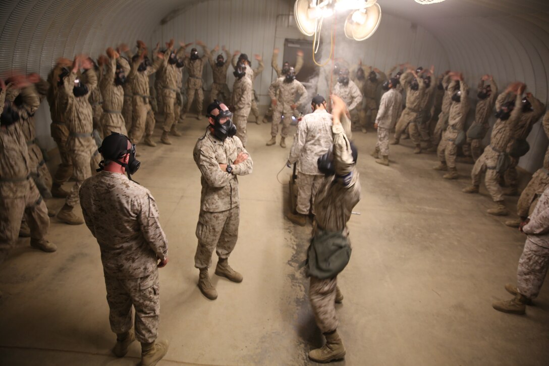 Drill instructors watch over recruits of India Company, 3rd Recruit Training Battalion, as the Confidence Chamber fills with CS gas. The reruits are requred to conduct exercises in the chamber at Edson Range, Marine Corps Base Camp Pendleton, Calif.,July 14. CS gas is a non-lethal tear gas and a riot control agent.