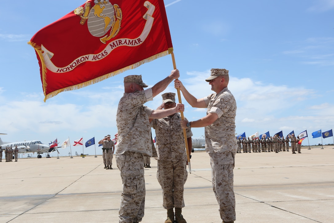 Lt. Col. Daniel J. Levasseur (right) hands over the Headquarters and Headquarters Squadron flag to Lt. Col. Mitchell A. Criger during a change of command ceremony aboard Marine Corps Air Station Miramar, Calif., July 18. Levasseur took command of H&HS in May 2012, and is slated to take over as detachment commander for Marine Fixed Wing Transport Squadron aboard MCAS Miramar.