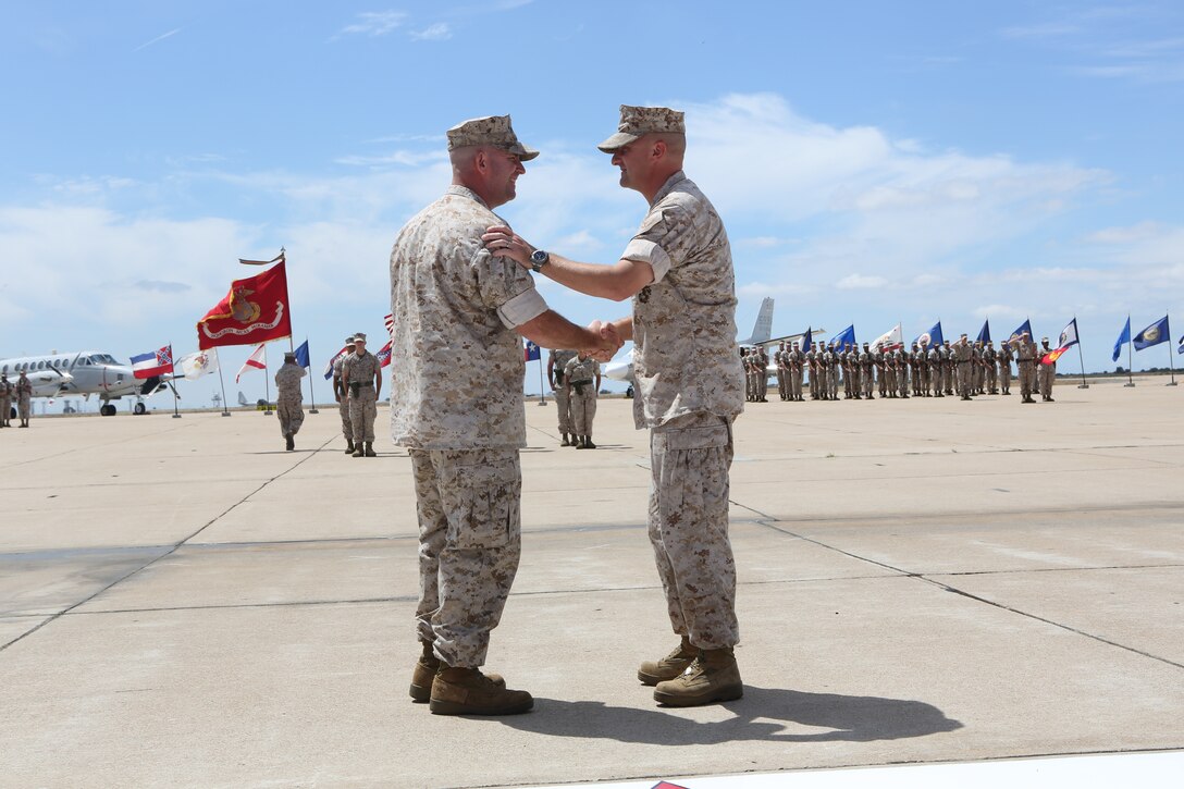 Lt. Col. Daniel J. Levasseur (right) shakes hands with the new Headquarters and Headquarters Squadron commanding officer,  Lt. Col. Mitchell A. Criger, during a change of command ceremony aboard Marine Corps Air Station Miramar, Calif., July 18. Criger, commanding officer, previously worked as the enlisted monitor section head in the Enlisted Assignments Branch for Plans, Policies and Operations at Headquarters Marine Corps, Manpower and Reserve Affairs in Quantico, Va.