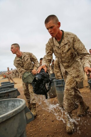 Recruit Esteban AldereteGonzalez, Platoon 3201, India Company, 3rd Recruit Training Battalion, washes his gas mask after completing the Confidence Chamber at Marine Corps Base Camp Pendleton, Calif., July 14. AldereteGonzalez is a Fonatana, Calif., native and was recruited out of Recruiting Substation Fonatana, Calif.	