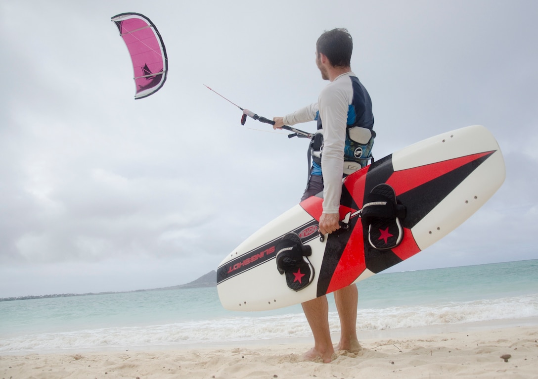 Kailua resident Erik Horn prepares to enter the water to go kiteboarding at Kailua Beach Park, July 14, 2014. Kiteboarding is a recreational water sport with various styles and terrain. Many people come ot Kailua Beach Park to kiteboard. (U.S. Marine Corps photo by Kristen Wong)