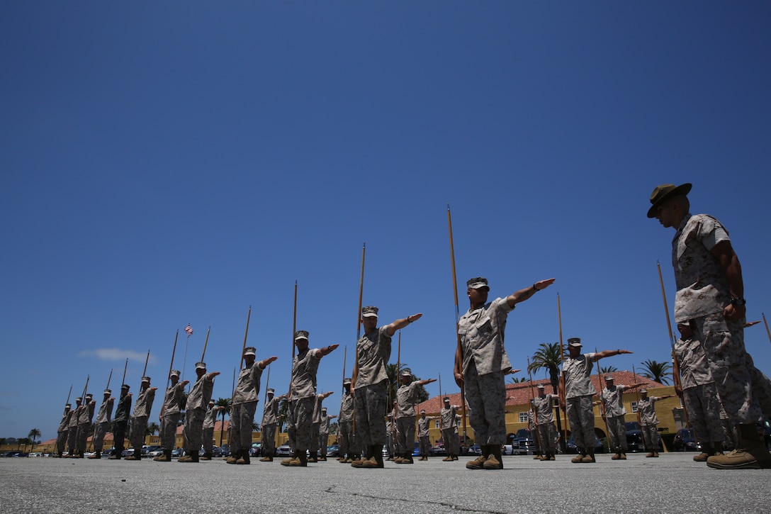Students of Drill Instructor School perform the drill movement ‘dress, left, dress’ with the guidon at Marine Corps Recruit Depot San Diego, July 10, 2014. Students are required to learn the basic guidon manual so they can effectively teach it to their recruits once they become drill instructors.