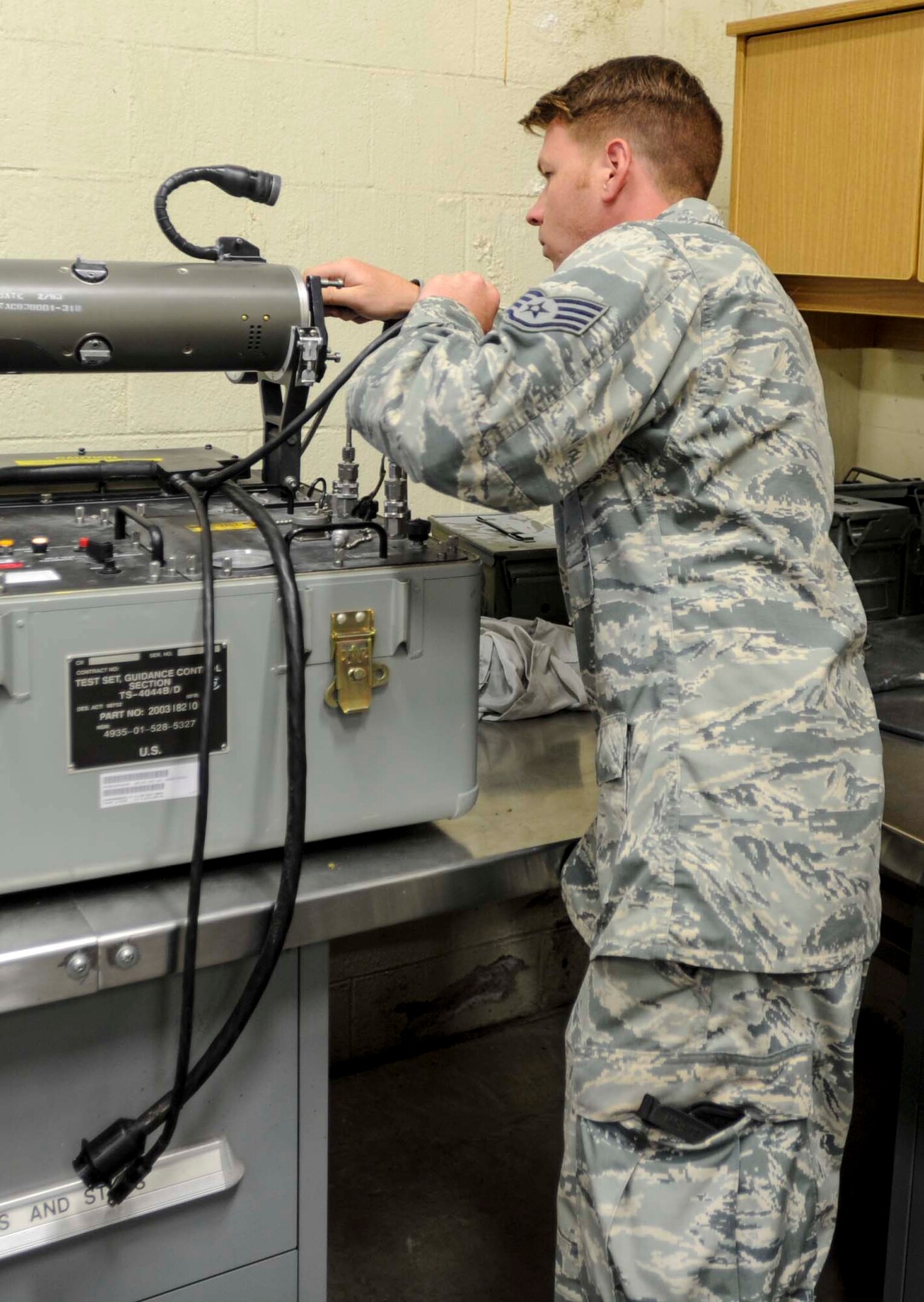 Staff Sgt. Travis Briese, 391st Fighter Squadron Munitions Flight equipment maintainer, connects the Captive Air Training Missile 9-M head to a TSU 4044 test set for trouble shooting July 17, 2014. Briese is deployed to Joint Base Pearl Harbor-Hickam, Hawaii, from Mountain Home Air Force Base, Idaho, in support of Rim of the Pacific 2014. RIMPAC is a U.S. Pacific Command-hosted biennial multinational maritime exercise designed to foster and sustain international cooperation on the security of the world's oceans. (U.S. Air Force photo by Tech. Sgt. Terri Paden)