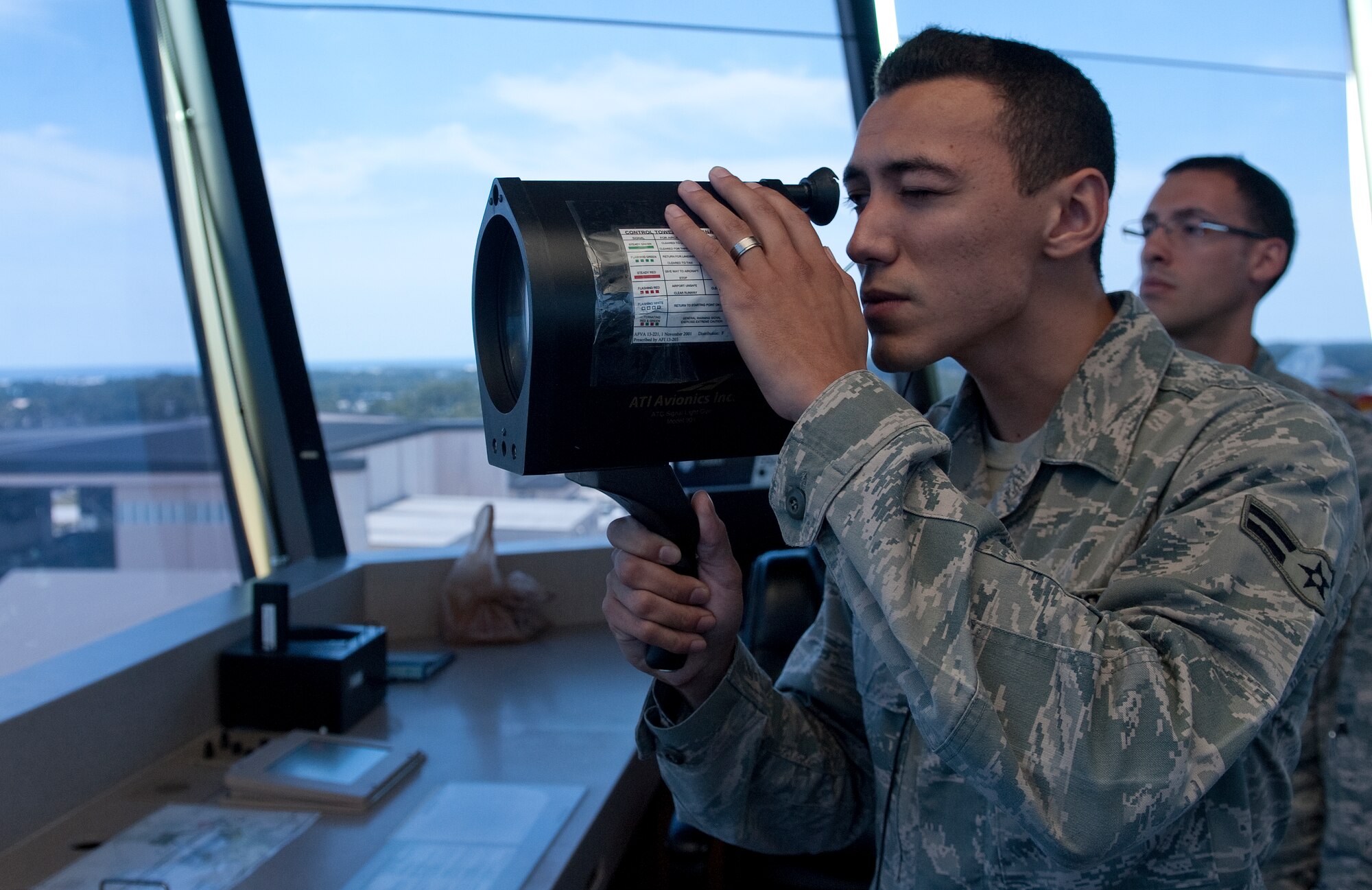 Airman 1st Class Patrick Ayoung, 1st Special Operations Support Squadron air traffic control apprentice, uses a signal light gun at the base flight tower on Hurlburt Field, Fla., July 17, 2014. Signal lights are used to direct planes, day or night, in case of a radio failure and aircraft not equipped with a radio. (U.S. Air Force photo/Senior Airman Kentavist P. Brackin)