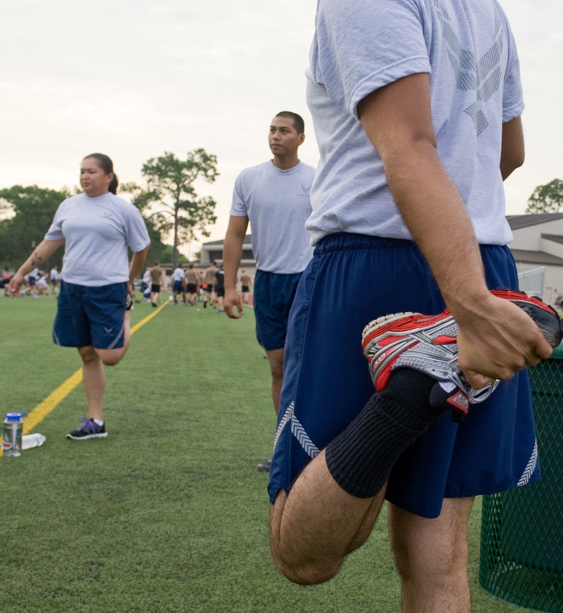 1st Special Operations Civil Engineer Squadron Airmen perform static stretches at the conclusion of their physical fitness training on Hurlburt Field, Fla., July 18, 2014. Static or nonmoving stretches are recommended at a workout's conclusion while dynamic or moving stretches are recommended prior to starting. (U.S. Air Force photo/Senior Airman Kentavist P. Brackin)