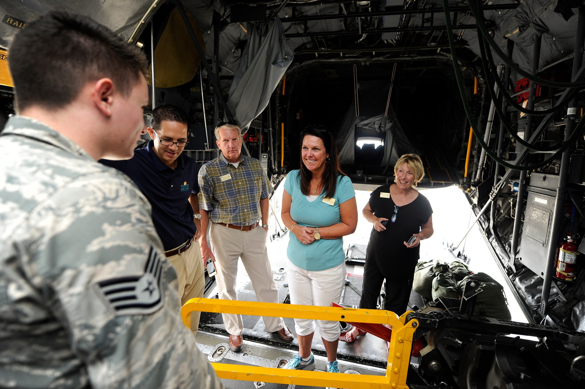 Honorary commanders receive a weapons briefing by Staff Sgt. Christopher Schiller, 4th Special Operations Squadron special missions aviator, at Hurlburt Field, Fla., July 18, 2014. The honorary commanders visited various squadrons under the 1st Special Operations Group. (U.S. Air Force photo/Airman 1st Class Jeff Parkinson)