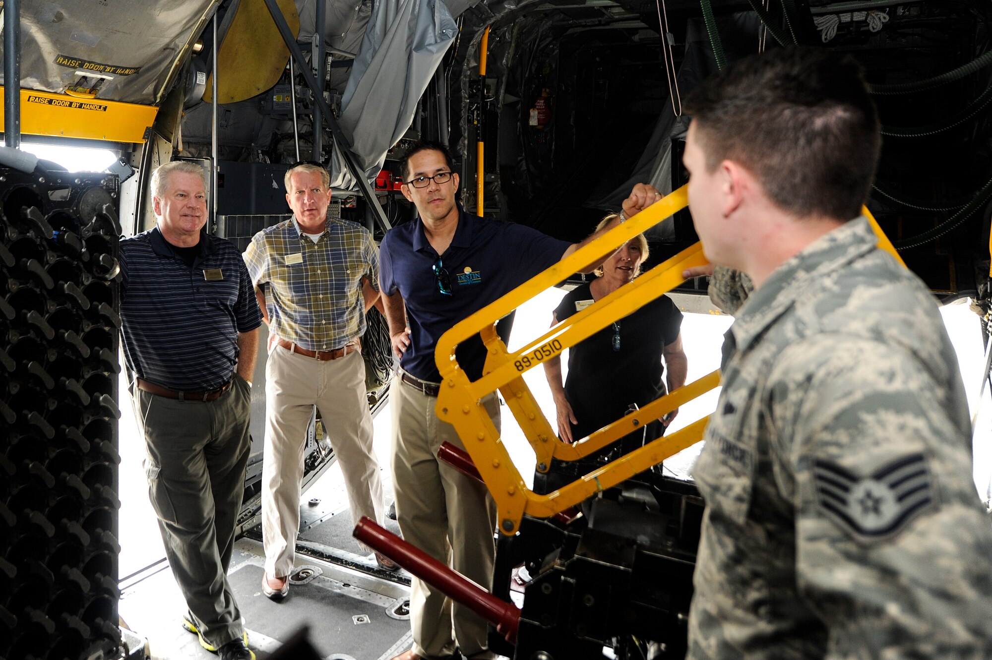 Honorary commanders receive a weapons briefing by Staff Sgt. Christopher Schiller, 4th Special Operations Squadron special missions aviator, at Hurlburt Field, Fla., July 18, 2014. The honorary commanders visited various squadrons under the 1st Special Operations Group. (U.S. Air Force photo/Airman 1st Class Jeff Parkinson)