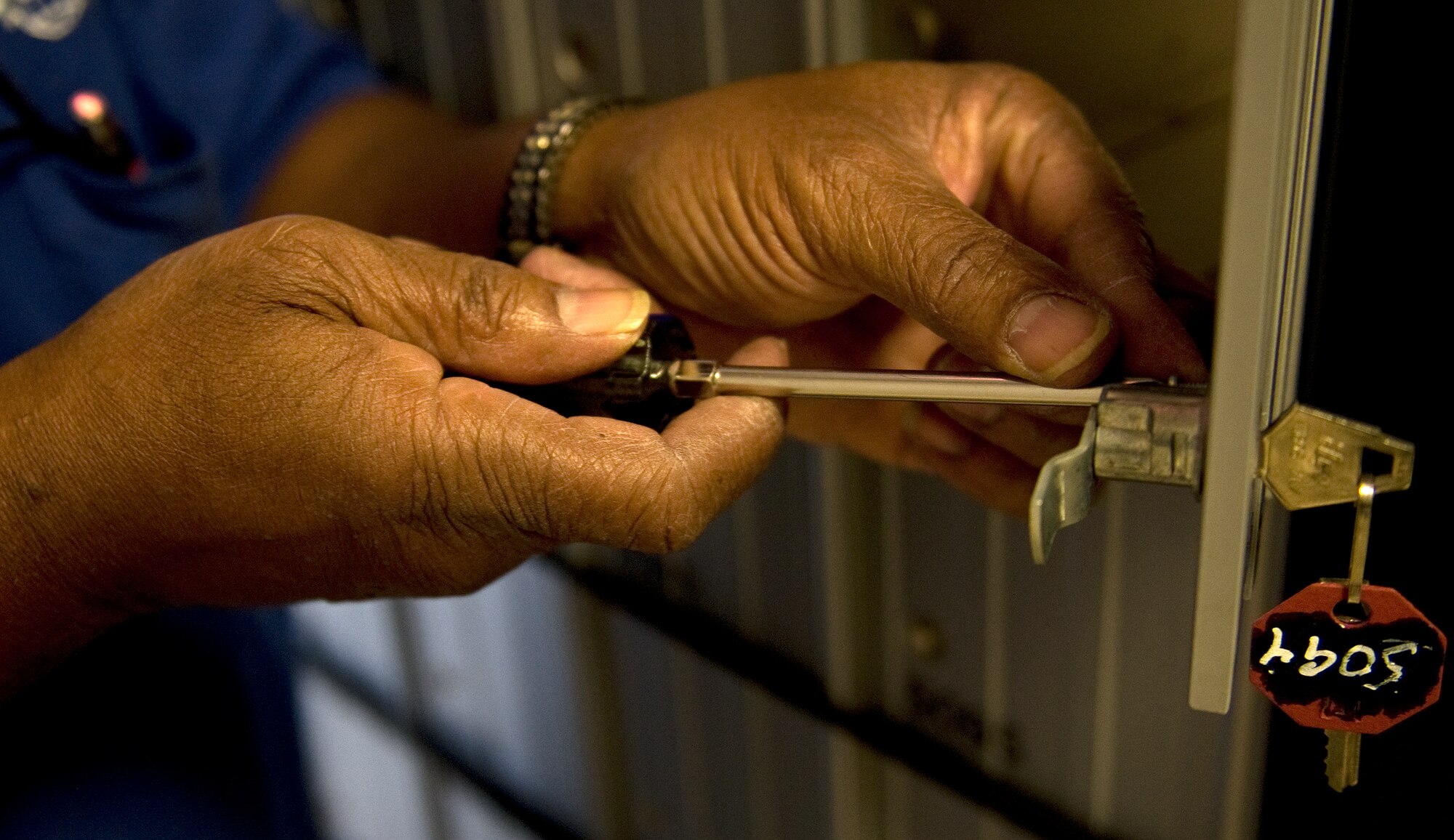James Bacon, Hurlburt Field Official Mail Center mail clerk, changes the lock for a mail locker at the post office on Hurlburt Field, Fla., July 16, 2014. The locks are changed when user change their mailing address to maintain integrity of mail lockers. (U.S. Air Force photo/Senior Airman Kentavist P. Brackin)