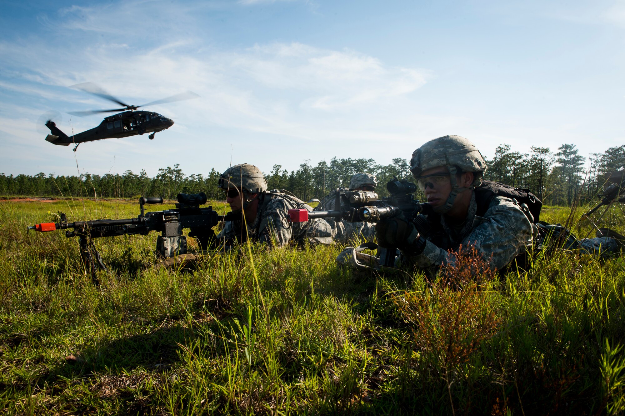 Soldiers from the 82nd Airborne Division provide security to a UH-60 Black Hawk during an infil and exfil training exercise on Eglin Range, Fla., July 17, 2014. The 1st Special Operations Support Squadron HAVE-ACE schedules and plans joint training to ensure U.S. Special Operations Command members are ready to deploy any time, any place.  (U.S. Air Force photo/Senior Airman Christopher Callaway) 