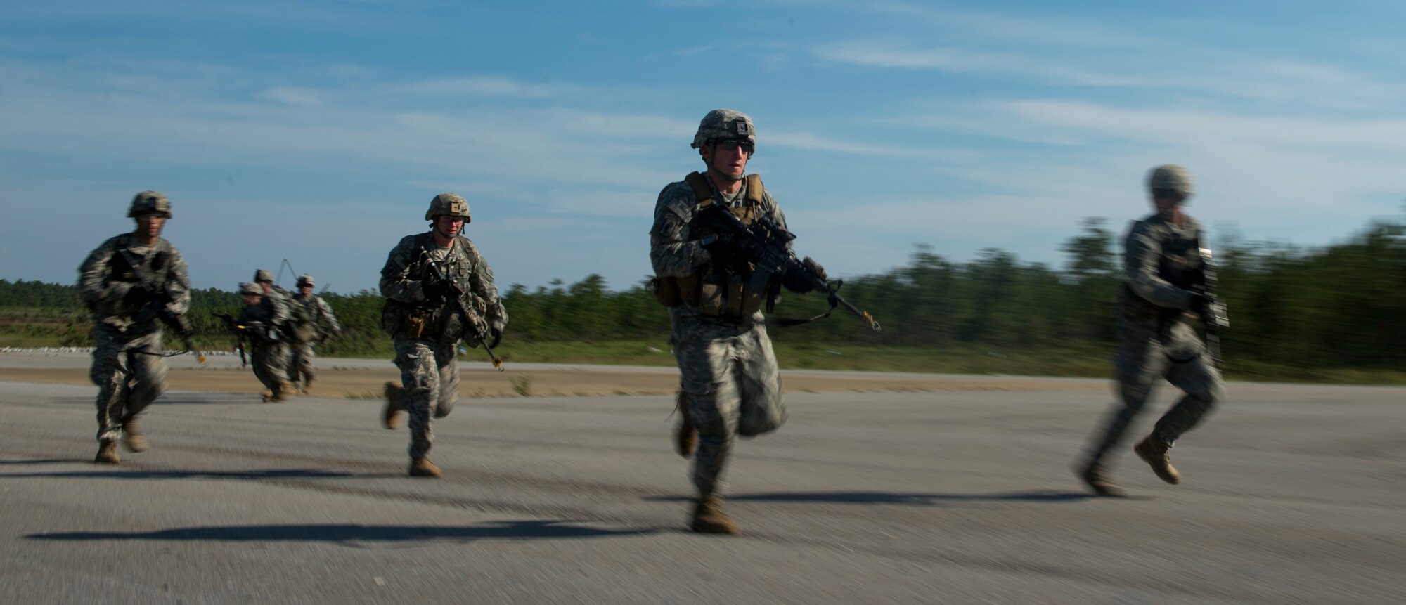 Soldiers from the 82nd Airborne Division run to take cover during an infil and exfil training exercise on Eglin Range, Fla., July 17, 2014. The 1st Special Operations Support Squadron HAVE-ACE schedules and plans joint training to ensure U.S. Special Operations Command members are ready to deploy any time, any place.  (U.S. Air Force photo/Senior Airman Christopher Callaway)