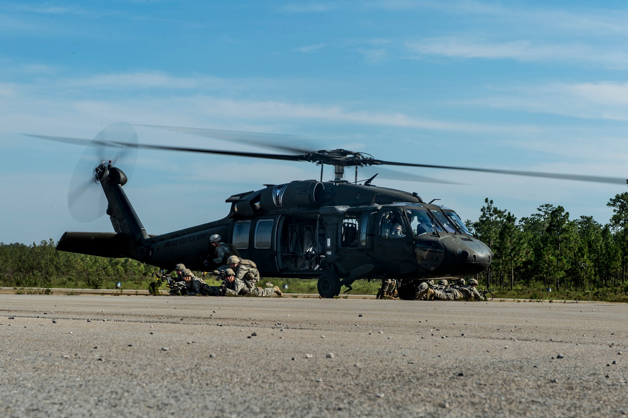 Soldiers from the 82nd Airborne Division provide security for a UH-60 Black Hawk during an infil and exfil training mission on Eglin Range, Fla., July 17, 2014. The 1st Special Operations Support Squadron HAVE-ACE schedules and plans joint training to ensure U.S. Special Operations Command members are ready to deploy any time, any place.  (U.S. Air Force photo/Senior Airman Christopher Callaway)