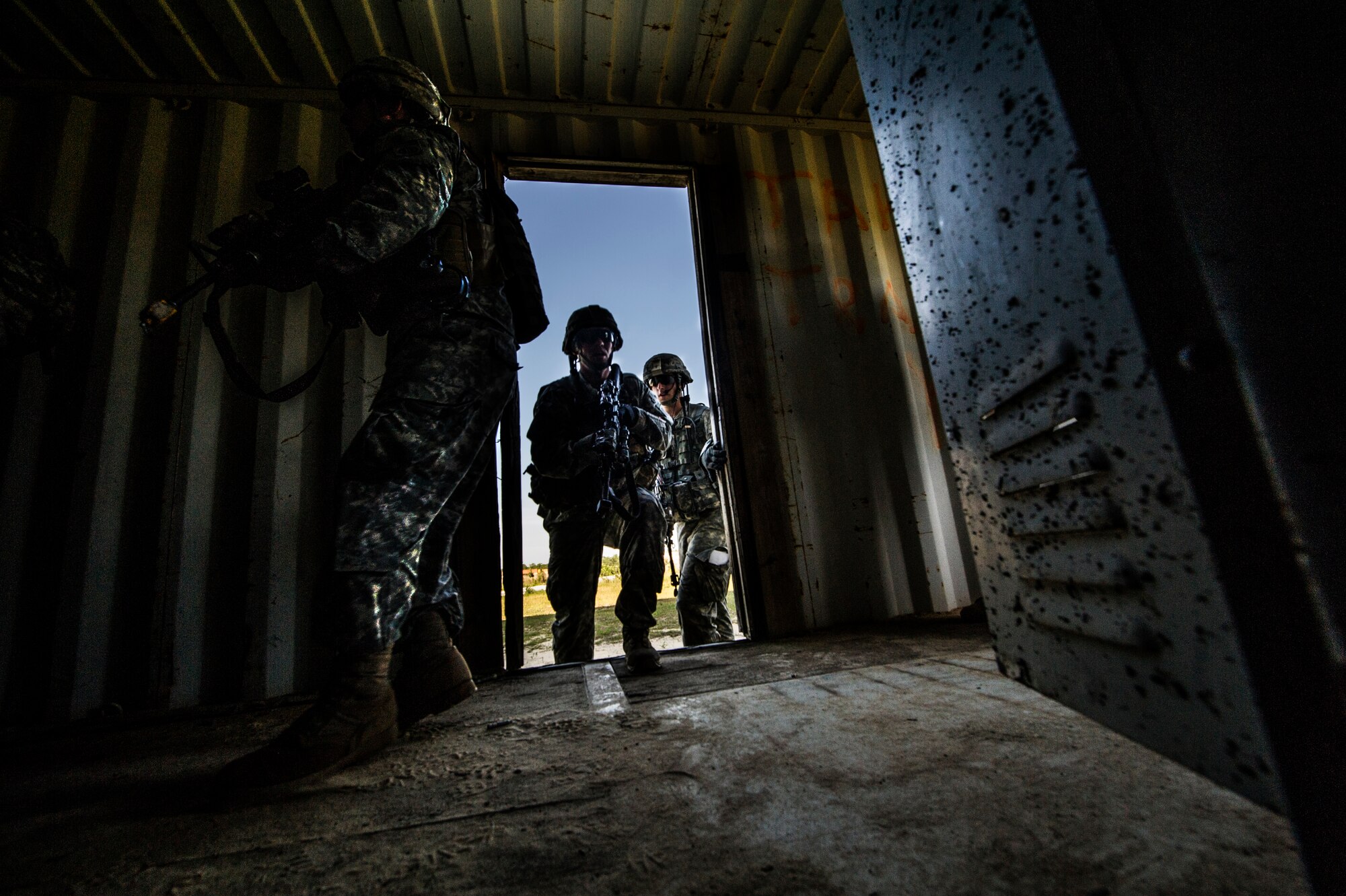 Soldiers from the 82nd Airborne Division clear a building during an infil and exfil training mission on Eglin Range, Fla., July 17, 2014. The 1st Special Operations Support Squadron HAVE-ACE hosted a joint training exercise to continue building trusted relationships with our joint combat teammates. (U.S. Air Force photo/Senior Airman Christopher Callaway)