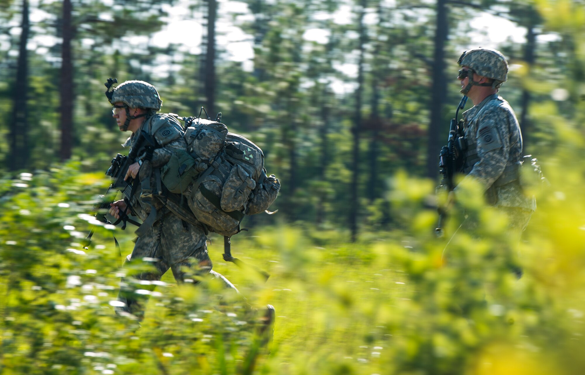 Soldiers from the 82nd Airborne Division run through bushes during an infil and exfil training exercise on Eglin Range, Fla., July 17, 2014. The 1st Special Operations Support Squadron HAVE-ACE hosted a joint training exercise to continue building trusted relationships with our joint combat teammates. (U.S. Air Force photo/Senior Airman Christopher Callaway)