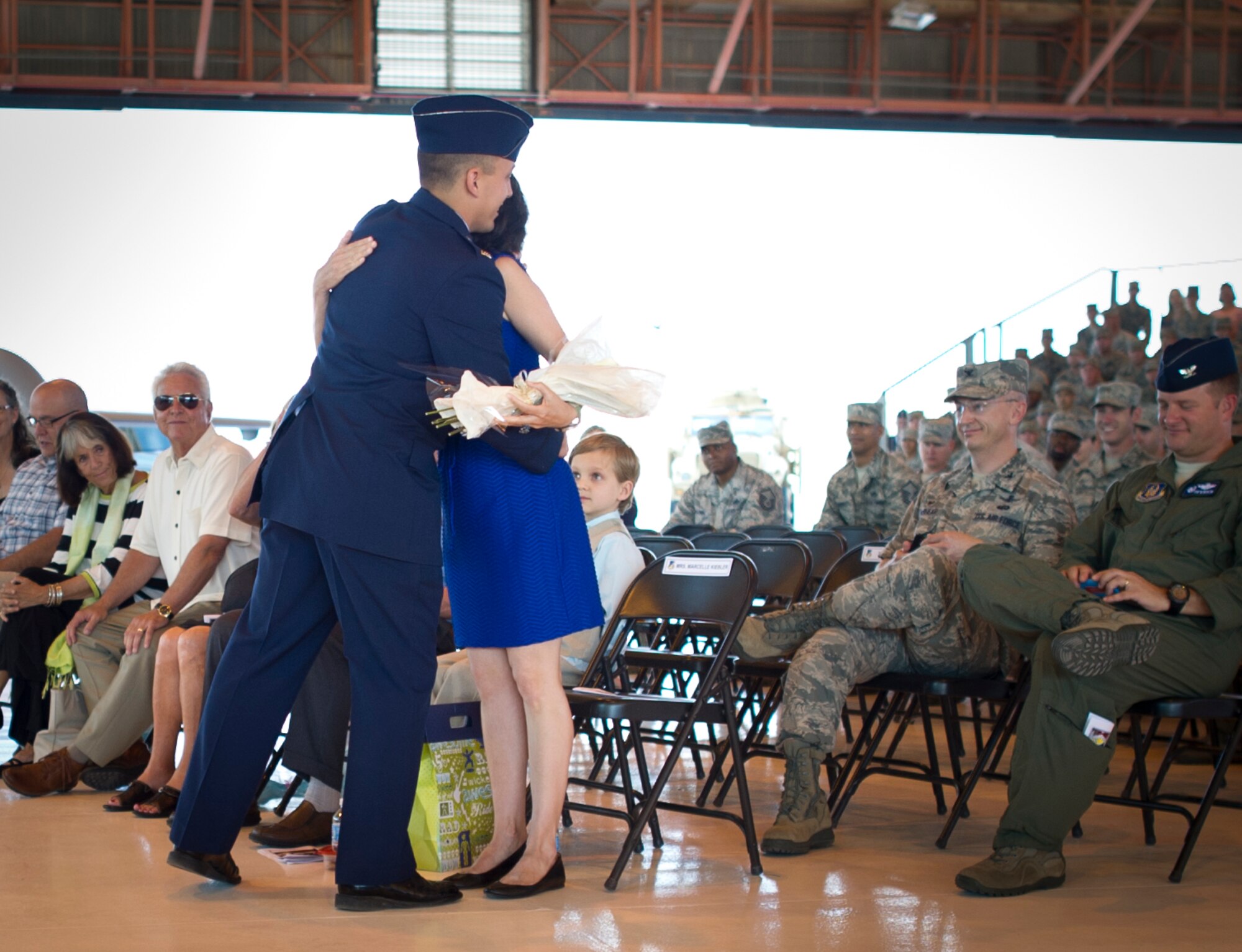 Colonel Robert Kiebler, 49th Wing commander, hugs his wife Marcelle Kiebler after his assumption of command ceremony at Holloman Air Force Base, N.M., July 18. An assumption or change of command is a military tradition that represents a formal transfer of authority and responsibility for a unit from one commanding officer to another. (U.S. Air Force photo by Staff Sgt. Stacy Moless / Released)