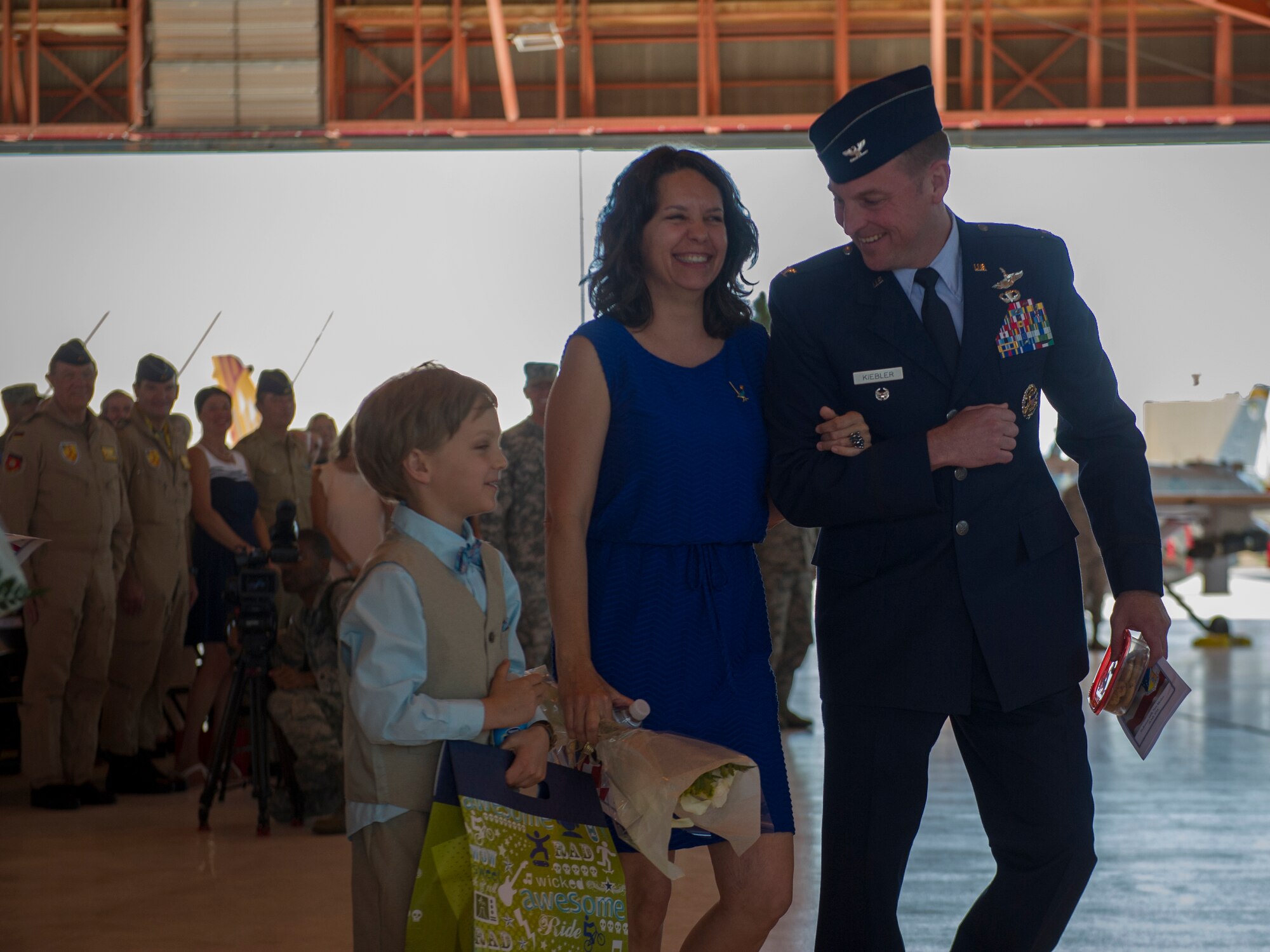 Colonel Robert Kiebler, 49th Wing commander, and his family depart hangar 500 after his assumption of command ceremony at Holloman Air Force Base, N.M., July 18. An assumption or change of command is a military tradition that represents a formal transfer of authority and responsibility for a unit from one commanding officer to another. (U.S. Air Force photo by Airman 1st Class Aaron Montoya / Released)