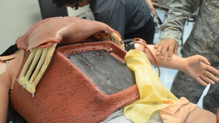 An emptied Tactical Combat Casualty Care Cut Suit showing the surface plate without synthetic organs.  The plate sits on top of a person’s chest to protect from damage or cuts from an actual scalpel during combat medical training.