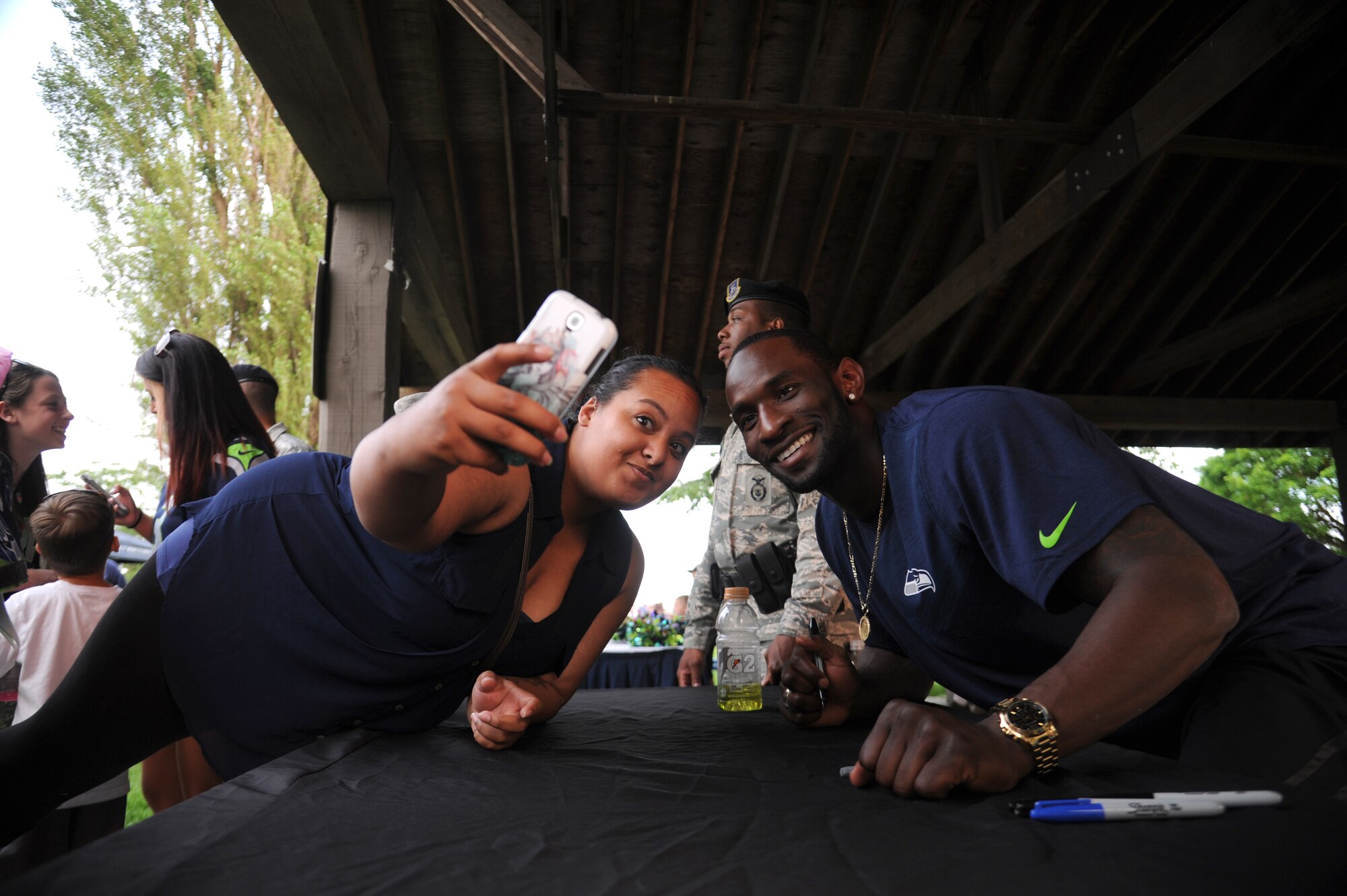 Ricardo Lockette takes a selfie with a Seattle Seahawks fan during the ‘Heros of 12’ Military Appreciation Tour at Fairchild Air Force Base, Washington, July 17, 2014. Lockette played in back to back Super Bowls, XLVII for the San Francisco 49ers and XLVIII with the Seattle Seahawks. Lockette plays wide receiver. (U.S. Air Force photo by Airman 1st Class Janelle Patiño/Released)