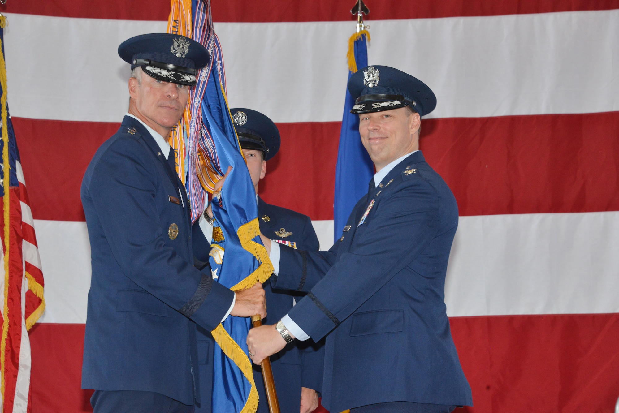 Maj. Gen. Michael Keltz, Director of Intelligence, Operations and Nuclear
Integration, Headquarters Air Education and Training Command, Joint Base San
Antonio Randolph, Texas, passes the wing flag to Col. Dagvin Anderson as he
takes command of the 58th Special Operations Wing July 18 inside an aircraft
hangar on Kirtland Air Force Base, N.M. (Photo by Dennis Carlson)
