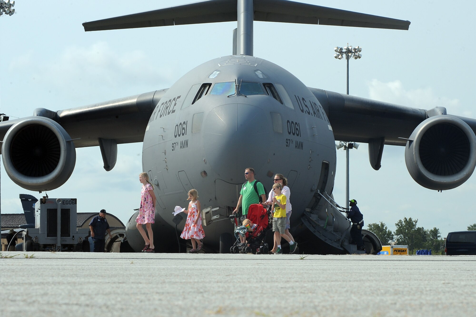 Tech. Sgt. Jamie Foehrweiser, from the 55th Intelligence Support Squadron, walks in front of a C-17 Globemaster during at the practice air show at Offutt Air Force Base, Neb., July 18. The Extrodinary Family Member Program with the Make-A-Wish foundation, Wounded Warriors and other special needs organizations team up with Team Offutt to give and exclusive air show experience one day prior to the scheduled weekend event.  (U.S. Air Force photo by Josh Plueger/Released).