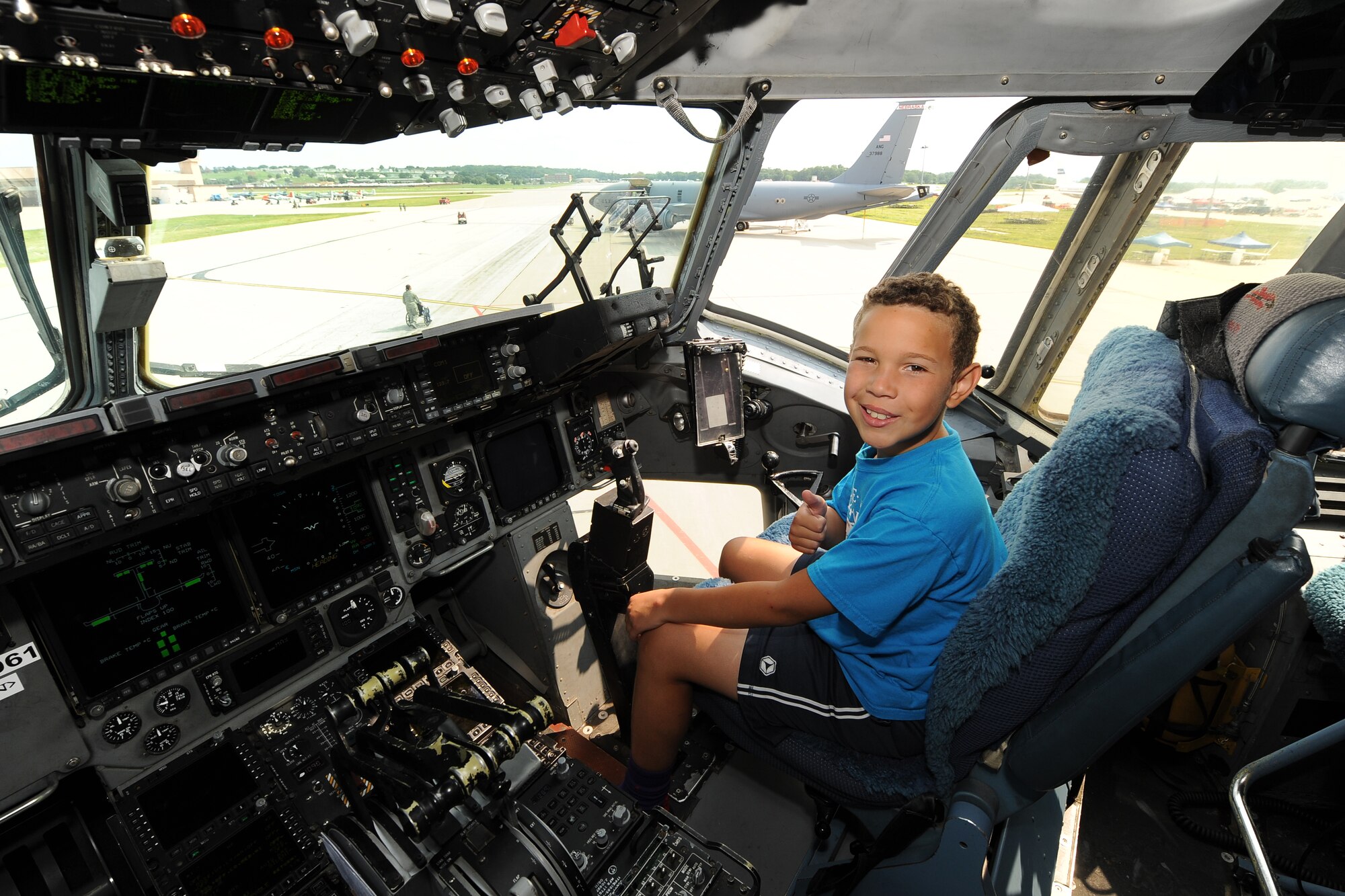 Paul Hays from Omaha, Neb., gives a thumbs-up in the cockpit of a C-17 Globemaster on the Offutt Air Force Base, Neb., on July 18. The practice air show is held the Friday before the scheduled 2014 Defenders of Freedom Open House and Air Show that draws more than a hundred thousand visitors to the base.  (U.S. Air Force photo by Josh Plueger/Released).