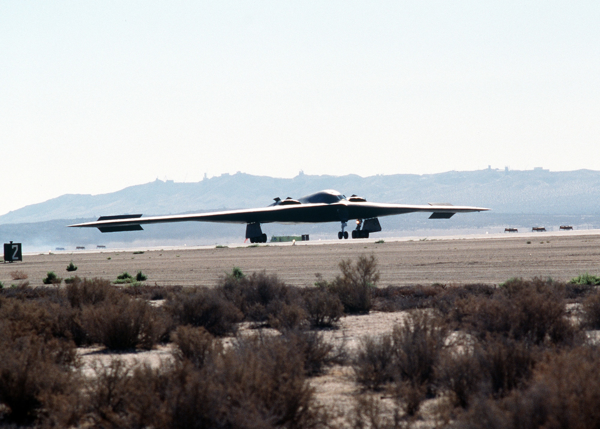 On July 17, 1989, Bruce Hinds, Northrup Grumman chief test pilot, and Col. Richard Couch, B-2 combined test force director, flew the first B-2 mission in the skies above California. The two-hour, 20-minute flight took both pilots on a mission from Air Force Plant 42 in Palmdale, to Edwards Air Force Base.  Pictured here is a right front view of a B-2 bomber aircraft taxiing during its first test flight at the Air Force Flight Test Center, Edwards Air Force Base, California.  In December, 1993, the first B-2, the "Spirit of Missouri," was delivered to Whiteman Air Force Base.  (photo by Rose Reynolds)