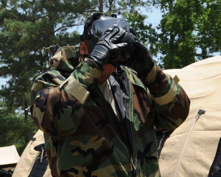 An Airman doffs his gas mask during an Ability to Survive and Operate Rodeo on Barksdale Air Force Base, La., July 10, 2014. Airmen from various units on base came together in a simulated deployed environment where they learned the basic skills needed to survive and operate. (U.S. Air Force photo/Staff Sgt. Sean Martin)