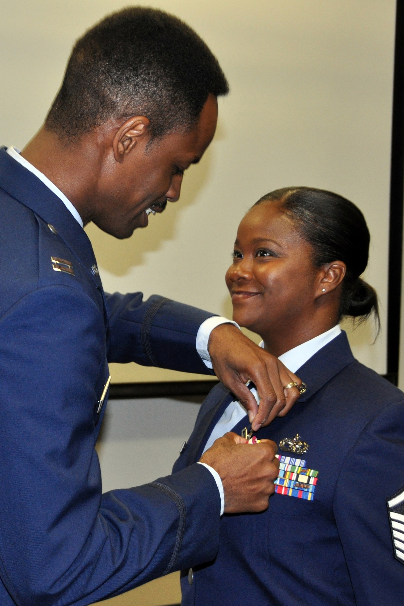 U.S. Air Force Capt. Kennie Neal, 2nd Bomb Wing Chaplain, presents the Meritorious Service Medal to Master Sgt. Sabrina Parker during her retirement ceremony, July 12, 2014, at Barksdale Air Force Base, La. Parker is awarded the medal for distinguished and meritorious service while assigned to the 307th Logistics Readiness Squadron. (U.S. Air Force photo by Master Sgt. Mary Hinson/Released)