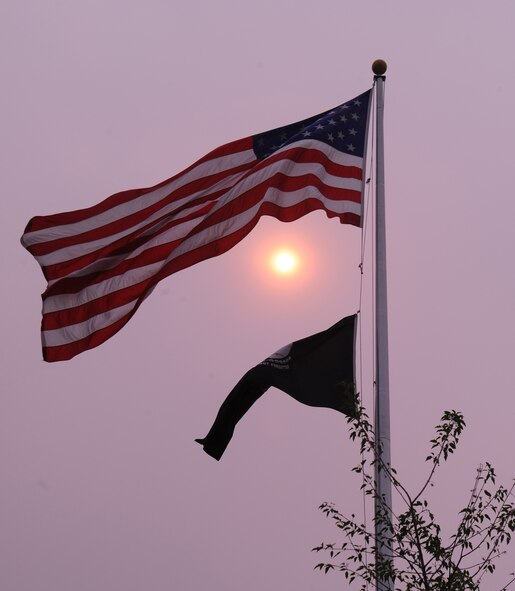 A cluster of four Washington wildfires have burned up to 100 homes and swelled to more than 260 square miles creating smoke and ash-filled skies over Fairchild Air Force Base, Washington, July 18, 2014. While Fairchild is not directly impacted by the fires, the smoke and ash may have medical implications, according to Washington State Department of Health officials. The fires are causing poor air quality in areas surrounding the fires. Wildfires contain fine particles and toxic chemicals that can be dangerous to breathe. For more information, visit the Washington State Department of Health public website at www.doh.wa.gov. (U.S. Air Force photo/Airman 1st Class Janelle Patiño)