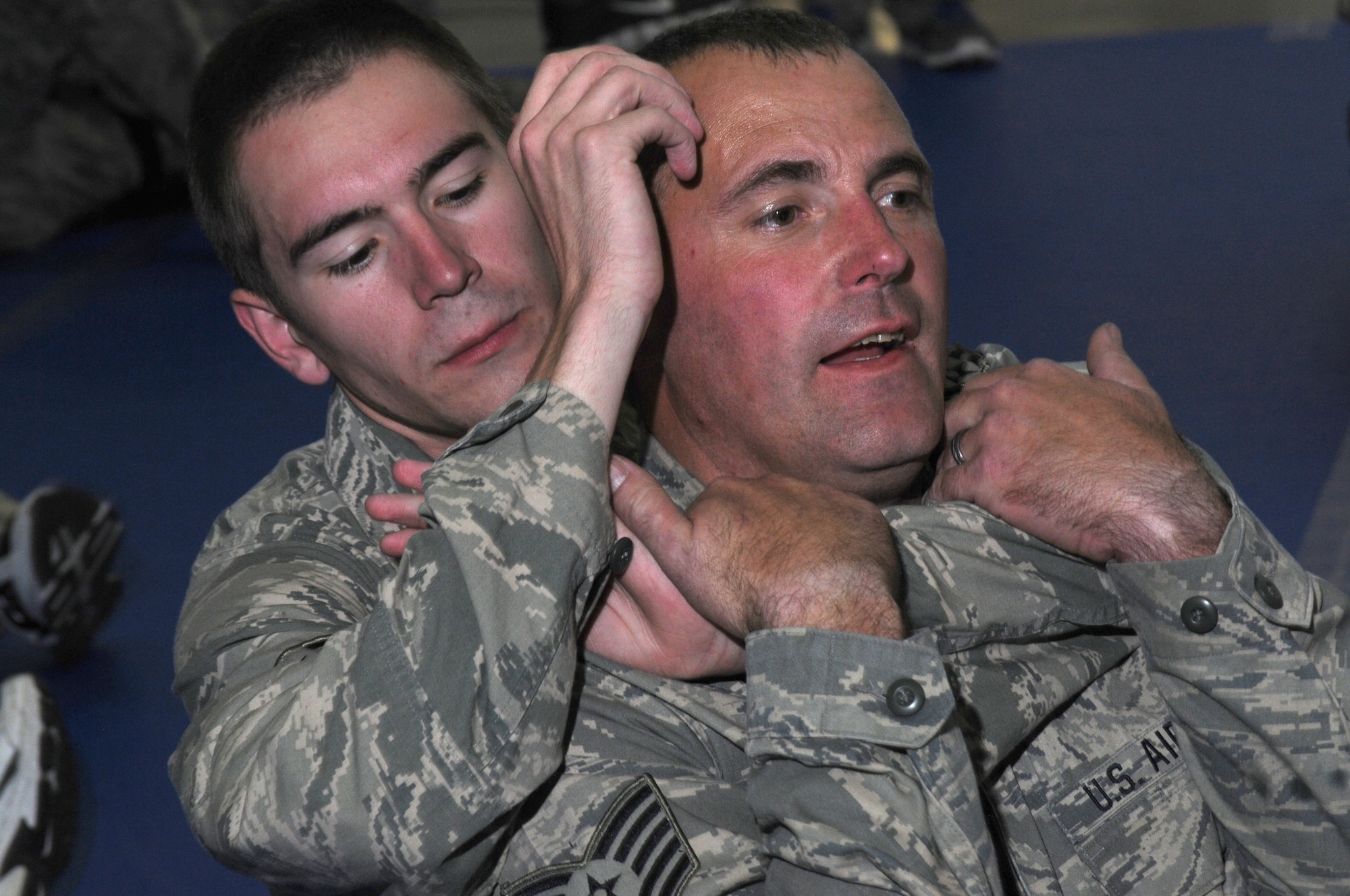 U.S. Air Force Tech. Sgt. Clinton Wells, 173rd Fighter Wing Security Forces Squadron, instructs Airman First Class Kodie Carroll, 173rd FW SFS, on how to properly restrain someone during combative skills training June 18, 2014 at Kingsley Field, Klamath Falls, Ore.  Members of the 173rd SFS spent two days learning self-defense and weapons retentions skills as part of an annual training exercise.  (U.S. Air National Guard photo by Master Sgt. Jennifer Shirar/Released)
