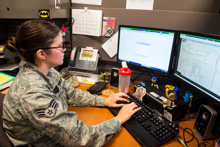 U.S. Air Force Senior Airman Jessica Treaster, 23d Comptroller Squadron customer service technician, processes a travel voucher at Moody Air Force Base, Ga., July 17, 2014. The 23d CPTS processes more than 30 permanent change of station travel vouchers weekly, each requiring nearly an hour to complete. (U.S. Air Force photo by Airman 1st Class Ceaira Tinsley/Released)