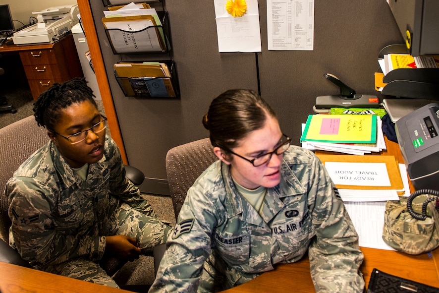 U.S. Air Force Senior Airman Jessica Treaster, 23d Comptroller Squadron customer service technician, trains U.S. Air Force Airman 1st Class Aneke Miller, 23d Comptroller Squadron customer service technician, on various computer programs at Moody Air Force Base, Ga., July 17, 2014. The 23d CPTS uses these programs for different things such as helping new Airman update their Basic Allowance for Housing. (U.S. Air Force photo by Airman 1st Class Ceaira Tinsley/Released)