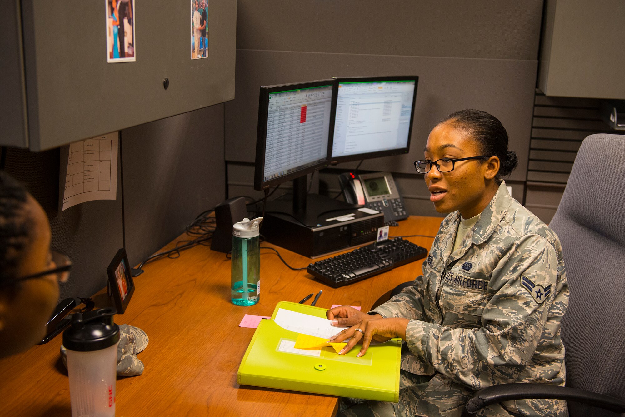 U.S. Air Force Airman 1st Class Rusheal Watson, 23d Comptroller Squadron administration support technician, discusses strategies to complete the various tasked assigned daily at Moody Air Force Base, Ga., July 17, 2014. Watson is tasked with updating physical fitness assessment scores and Airmen’s Enlistment and Officer Performance Report feedback into the system. (U.S. Air Force photo by Airman 1st Class Ceaira Tinsley/Released)