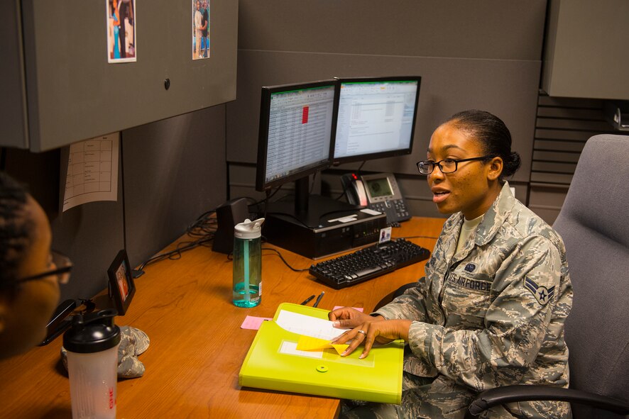 U.S. Air Force Airman 1st Class Rusheal Watson, 23d Comptroller Squadron administration support technician, discusses strategies to complete the various tasked assigned daily at Moody Air Force Base, Ga., July 17, 2014. Watson is tasked with updating physical fitness assessment scores and Airmen’s Enlistment and Officer Performance Report feedback into the system. (U.S. Air Force photo by Airman 1st Class Ceaira Tinsley/Released)