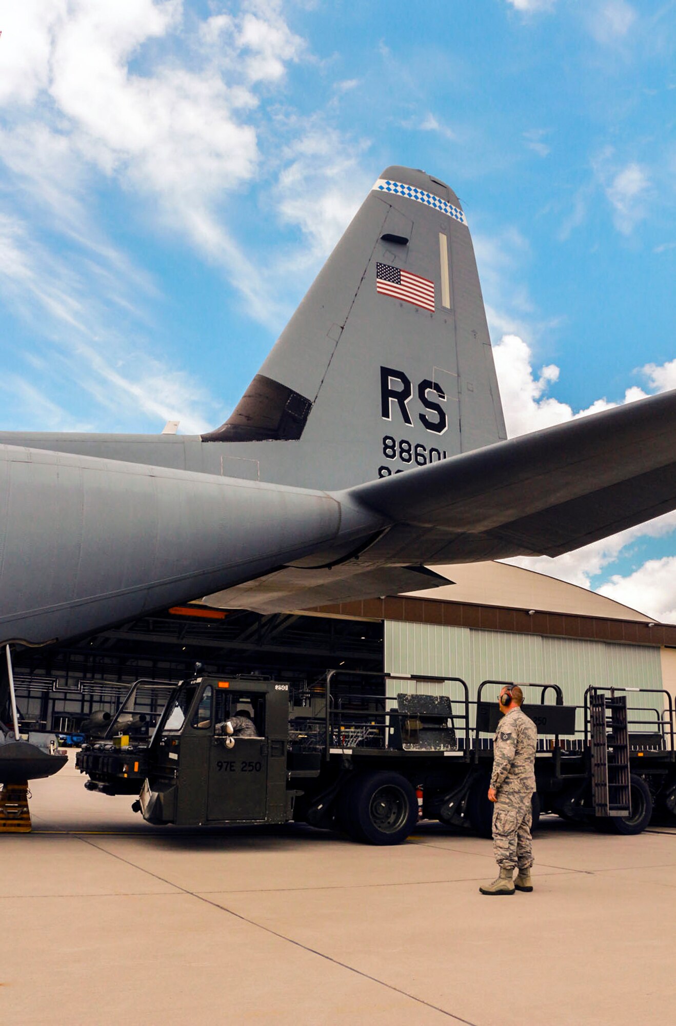 Tech. Sgt. Shawn Ensley, 36th Aerial Port Squadron air traffic operations controller, watches as a K-loader unloads a C-130 Hercules aircraft July 15 at Ramstein Air Base, Germany. Ensley is in charge of relaying the message between the load planner and the aircrew as well as keeping track of all cargo and passengers that arrive and depart base. (U.S. Air Force Reserve photo by Senior Airman Madelyn McCullough)