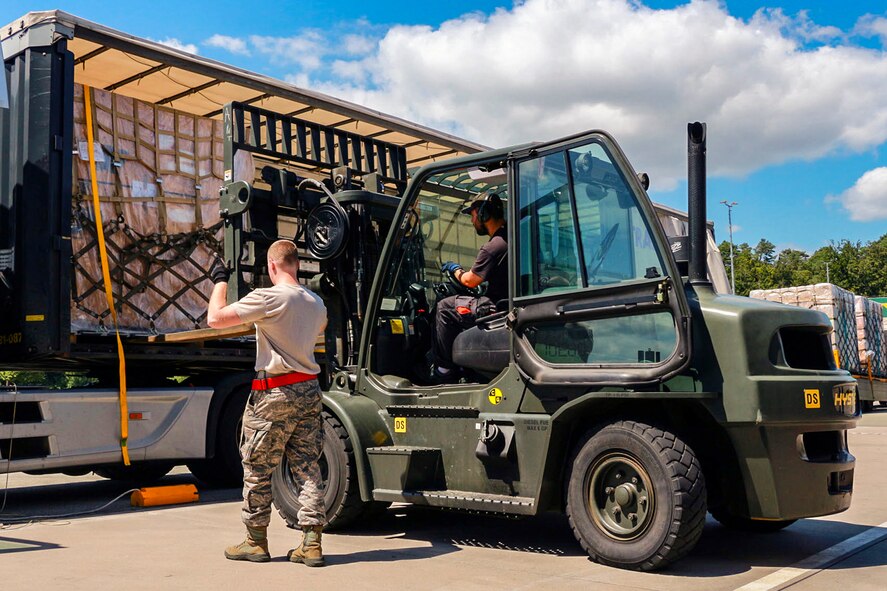 Senior Airman Bradley Sharp, 36th Aerial Port Squadron air transportation specialist, directs the unloading of a pallet July 14 at Ramstein Air Base, Germany. Sharp and other members of the squadron came to Germany from the 446th Airlift Wing at McChord Field, Washington, to practice real-life scenarios of job tasks they normally have to simulate. (U.S. Air Force Reserve photo by Senior Airman Madelyn McCullough)