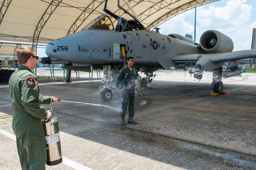 U.S. Air Force Lt. Col. David Rayman, 75th Fighter Squadron commander, receives showers of water after earning his 3,000th flight hour at Moody Air Force Base, Ga., July 17, 2014. Rayman has been flying the A-10C Thunderbolt II for 12 years. (U.S. Air Force photo by Airman 1st Class Ryan Callaghan/Released)