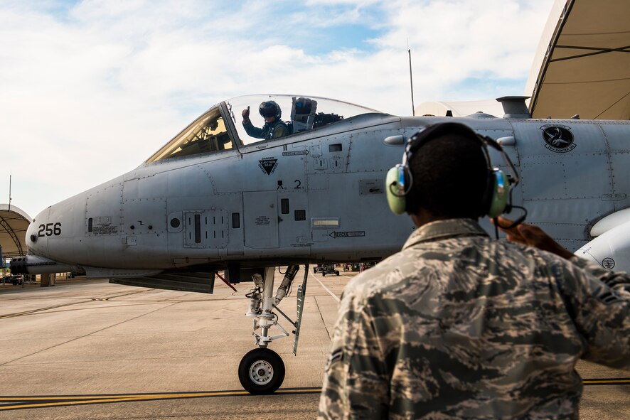 U.S. Air Force Lt. Col. David Rayman, 75th Fighter Squadron commander, gives a thumbs up after returning a customary salute at Moody Air Force Base, Ga., July 17, 2014. After preflight checks are complete, the ground crew member salutes the pilot as he enters the taxiway to signify transfer of control over the aircraft. (U.S. Air Force photo by Airman 1st Class Ryan Callaghan/Released)