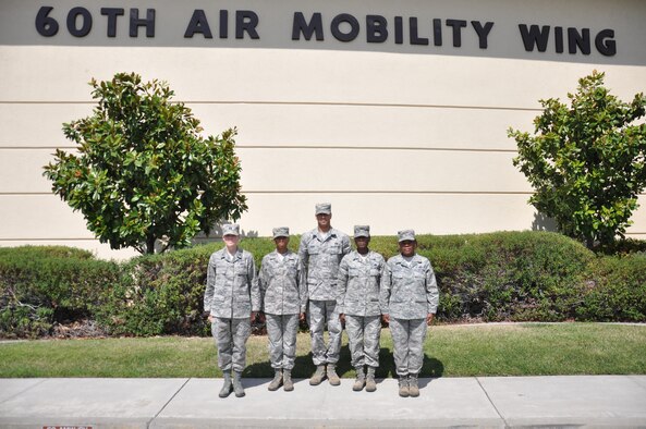 Members of the 60th Air Mobility Wing Protocol team stand July 15, 2014, in front of the 60th AMW headquarters building for a photo. From left to right are Capt. Jamie Johnson, Staff Sgt. Asia Cook, Tech. Sgt. Lennex Dennis, Tech. Sgt. Shametra Medlock and Senior Master Sgt. Alicia Skinner. Not pictured is Staff Sgt. Ian Stevens. Together, they support all three wings at Travis as well as partner units. (U.S. Air Force photo/Staff Sgt. Christopher Carranza)