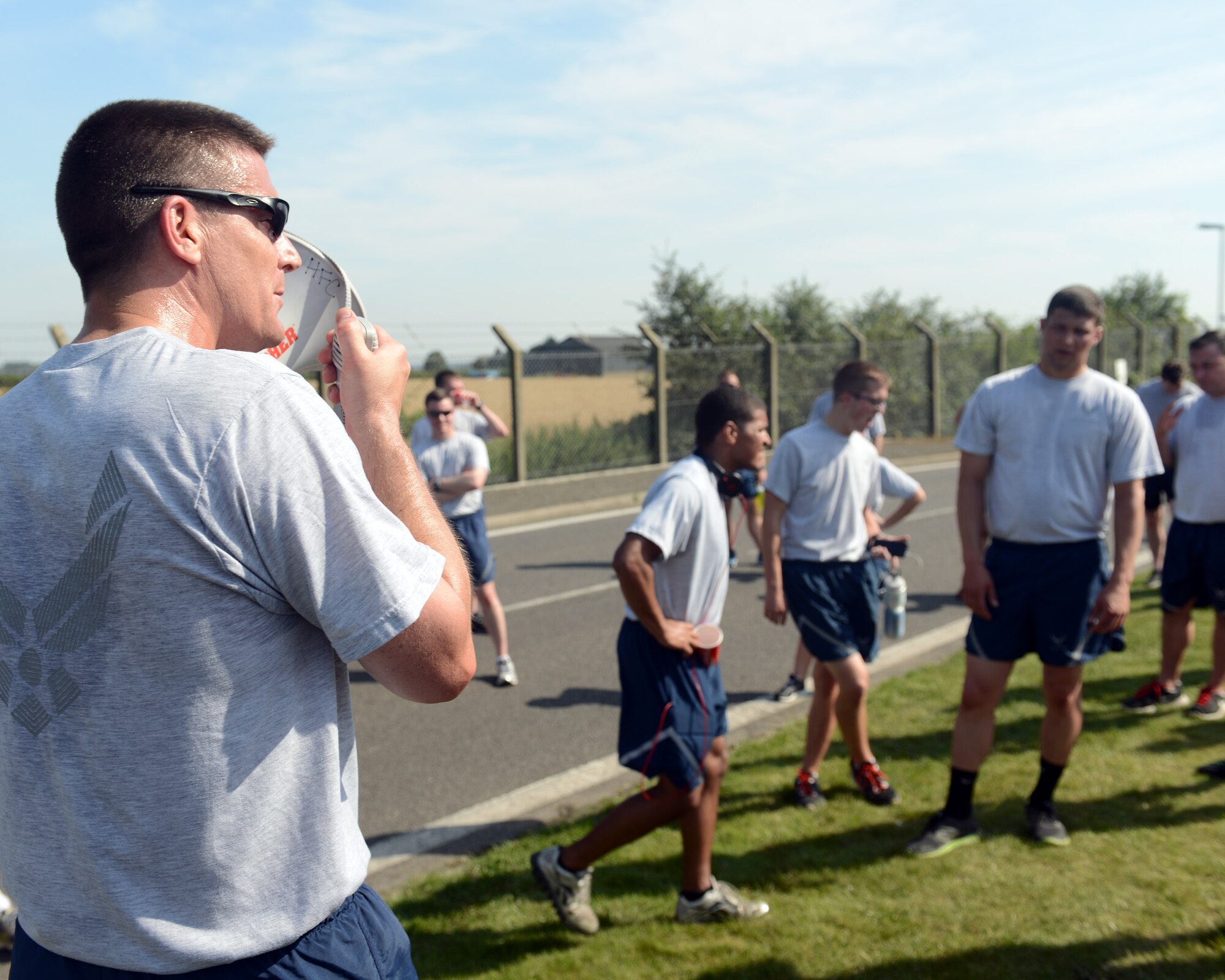 U.S. Air Force Chief Master Sgt. Tracy Jones, 100th Air Refueling Wing command chief, speaks to wing run participants July 18, 2014, on RAF Mildenhall, England. The monthly 5 km run encourages morale and camaraderie throughout the base. (U.S. Air Force photo/Airman 1st Class Preston Webb/Released)