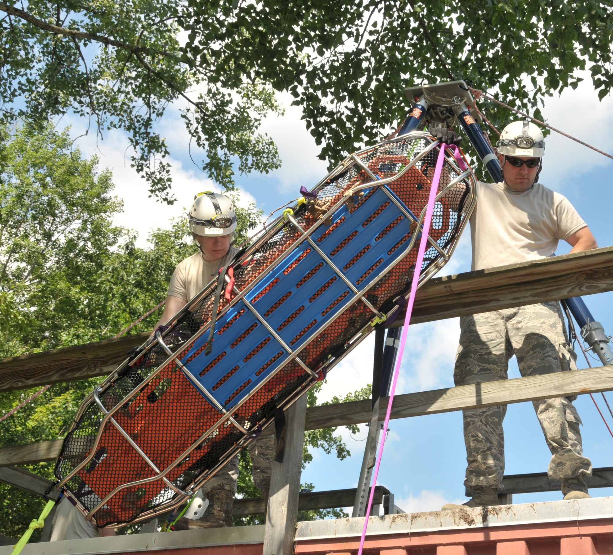 Senior Airman Jodie Ruther (left) and Staff Sgt. Stephen Bogart with the 109th Civil Engineer Squadron's Fire Department complete search and rescue training at Stratton Air National Guard Base, Scotia, New York, on July 17, 2014. Twelve firefighters participated in the training and more will take part in the coming months. The 109th AW rescue team leads a consolidated New York Air National Guard team comprised of personnel from the 106th Rescue Wing, Westhampton Beach, New York, and the 105th AW, Newburgh, New York. The teams are part of the National Guard Bureau's Domestic Operations Concept of Operations, supporting civil authorities as part of the National Response Framework. (U.S. Air National Guard photo by Master Sgt. William Gizara/Released)