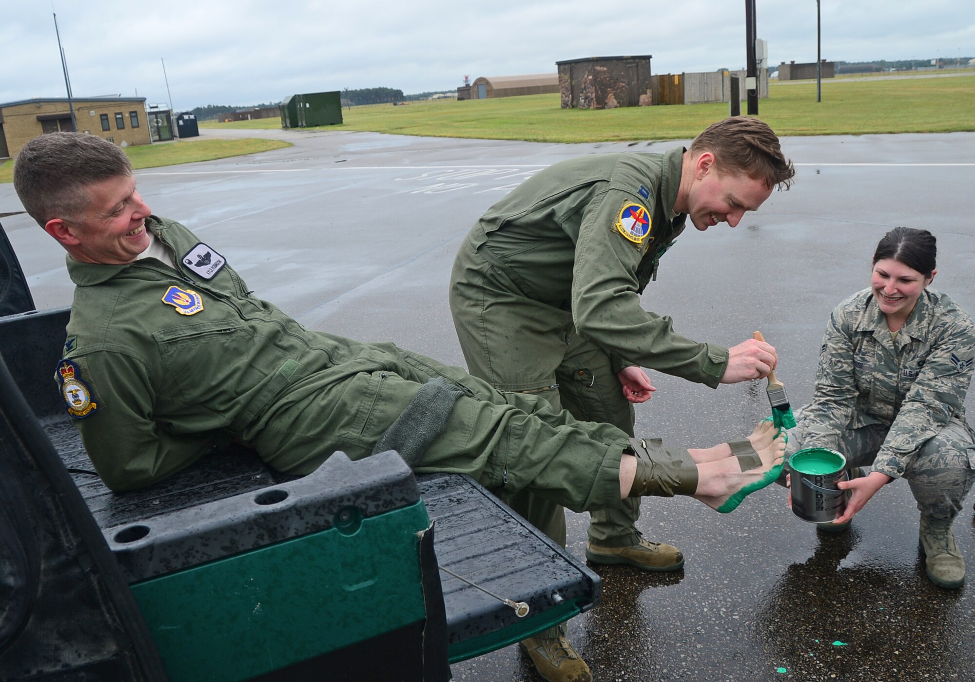 Members of the 56th Rescue Squadron paint 48th Fighter Wings Commander Col. Kyle Robinson’s feet green after completing his final flight at Royal Air Force Lakenheath, England, July 10, 2014. After serving as the 48th FW commander for more than two years, Robinson has been assigned to the Pentagon. (U.S. Air Force photo by Airman 1st Class Erin O’Shea/Released)