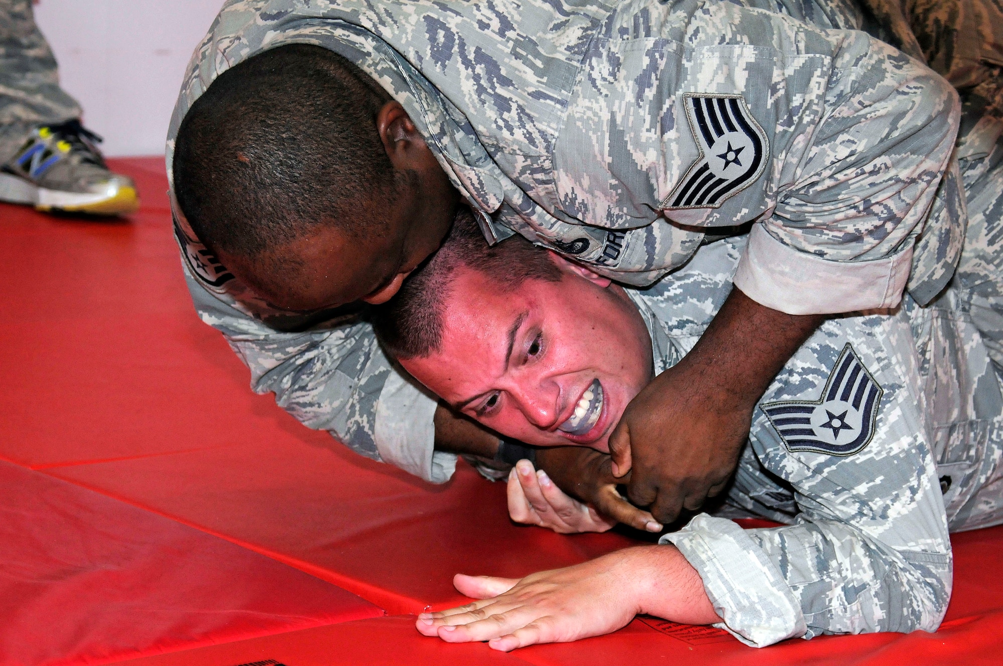 Staff Sgt. Derrek J. Deans "Submits" Staff Sgt. Alan J. Batema from the
482nd Security Forces Squadron during a training exercise at Homestead Air
Reserve Base, Fla., July 15. The Security Forces Combative Training is
designed to teach defenders how to handle situations when they are in
hand-to-hand combat with the enemy. (U.S. Air Force photo/Senior Airman
Nicholas Caceres)
