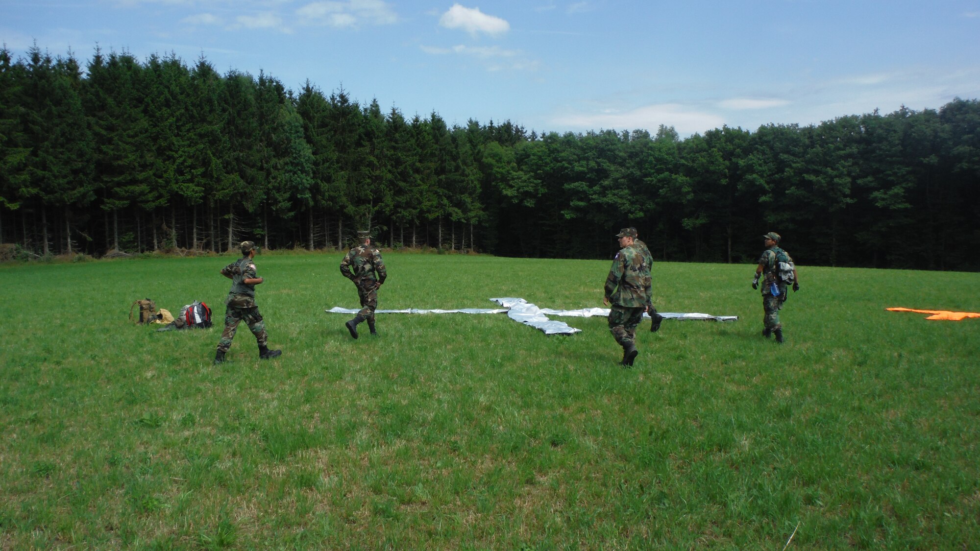 Civil Air Patrol cadets set up an air-to-ground panel July 6, 2014, in Luxembourg. The panels communicate from the ground team to an aircraft overhead, and the way the cadets set up the signal panels sends a message to the pilot, ranging from someone requiring medical assistance to mission complete. (U.S. Air Force courtesy photo/Released)