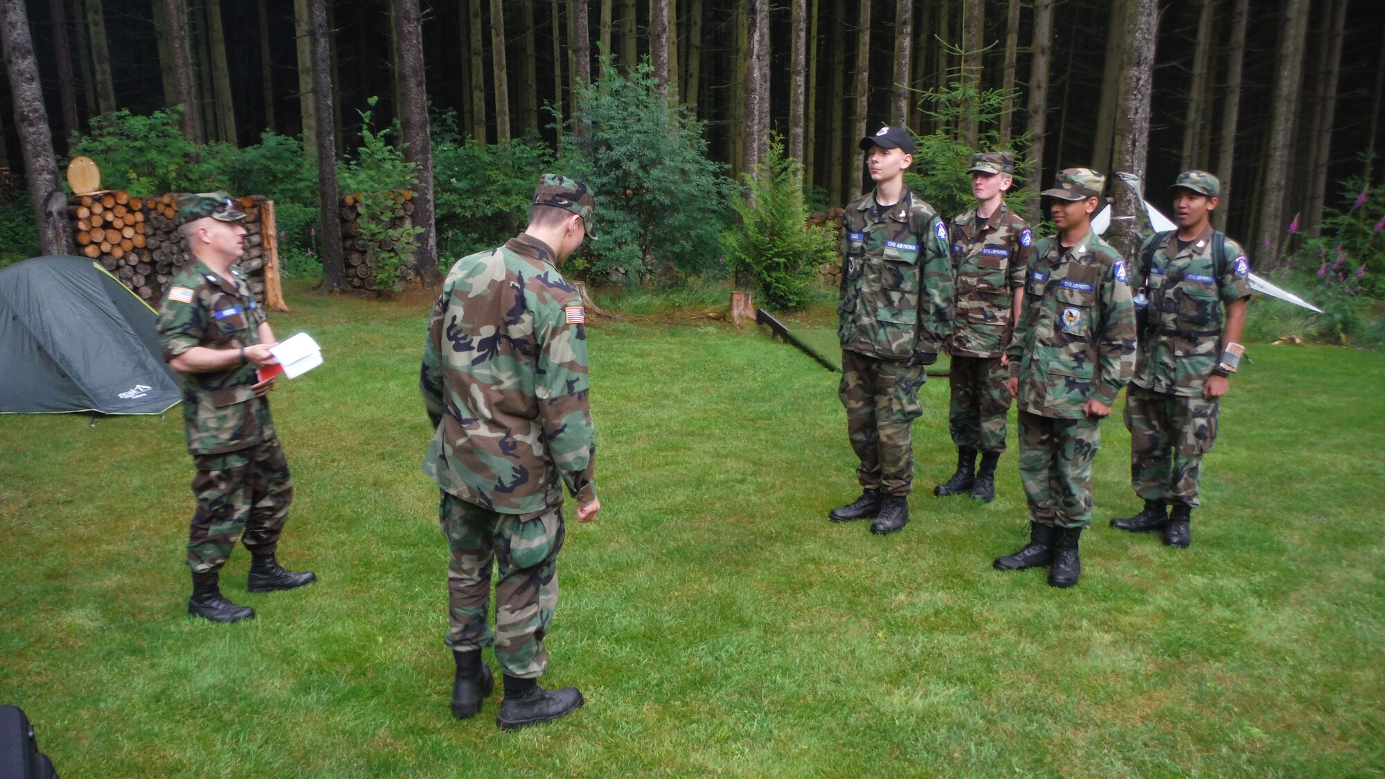 U.S. Air Force Lt. Col. Chad Morris, 52nd Mission Support Group deputy commander and senior Civil Air Patrol leader, conducts a lesson from a field-training guide in Luxembourg July 6, 2014, during a CAP training event. The cadets were preparing to perform a ground search and rescue exercise. (U.S. Air Force courtesy photo/Released)