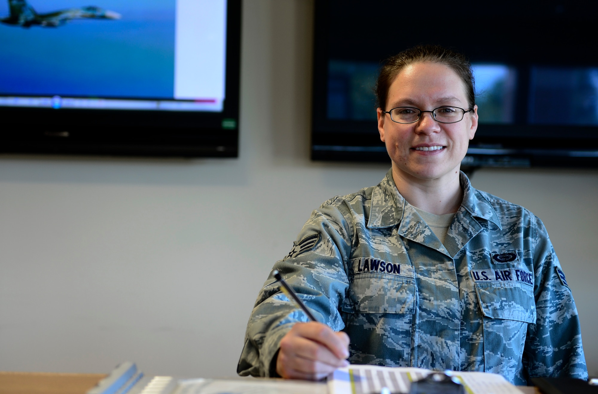 Senior Airman Samantha Lawson, 493rd Fighter Squadron intelligence analyst, reviews details in a report at Royal Air Force Lakenheath, England, July 17, 2014. Lawson was nominated for the Liberty Spotlight because she displays the core value of Service Before Self. (U.S. Air Force photo by Airman 1st Class Dawn M. Weber/Released)