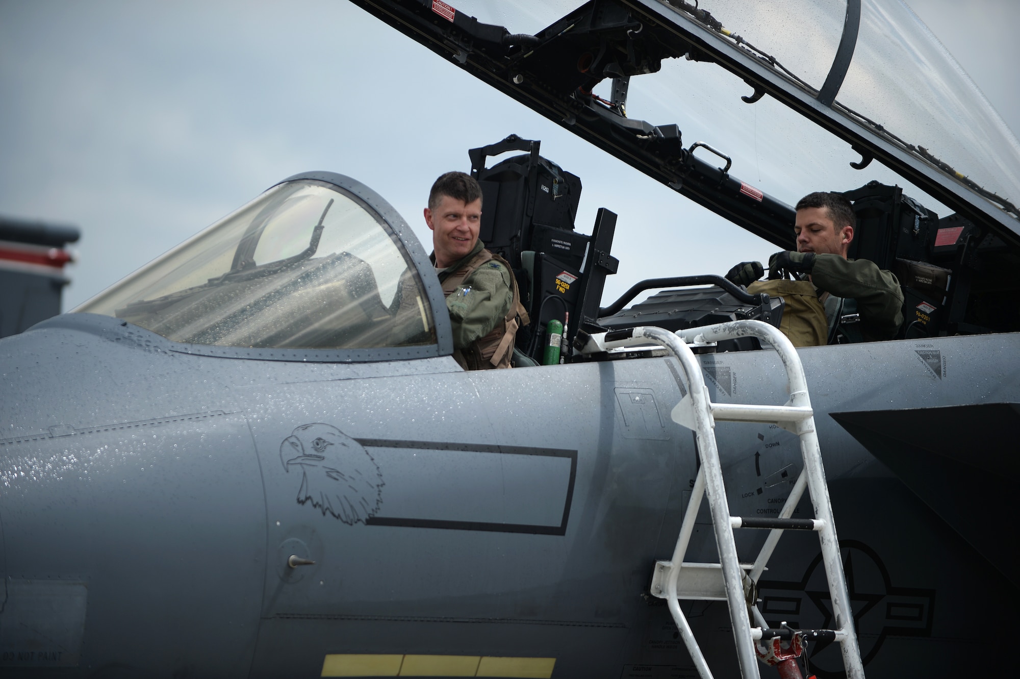 Col. Kyle Robinson, 48th Fighter Wing commander, prepares to climb out of an F-15E Strike Eagle after completing his final flight at Royal Air Force Lakenheath, England, July 17, 2014. Robinson is a command pilot with flying experience in the B-1B Lancer bomber and the Strike Eagle. (U.S. Air Force photo by Staff Sgt. Emerson Nuñez/Released)