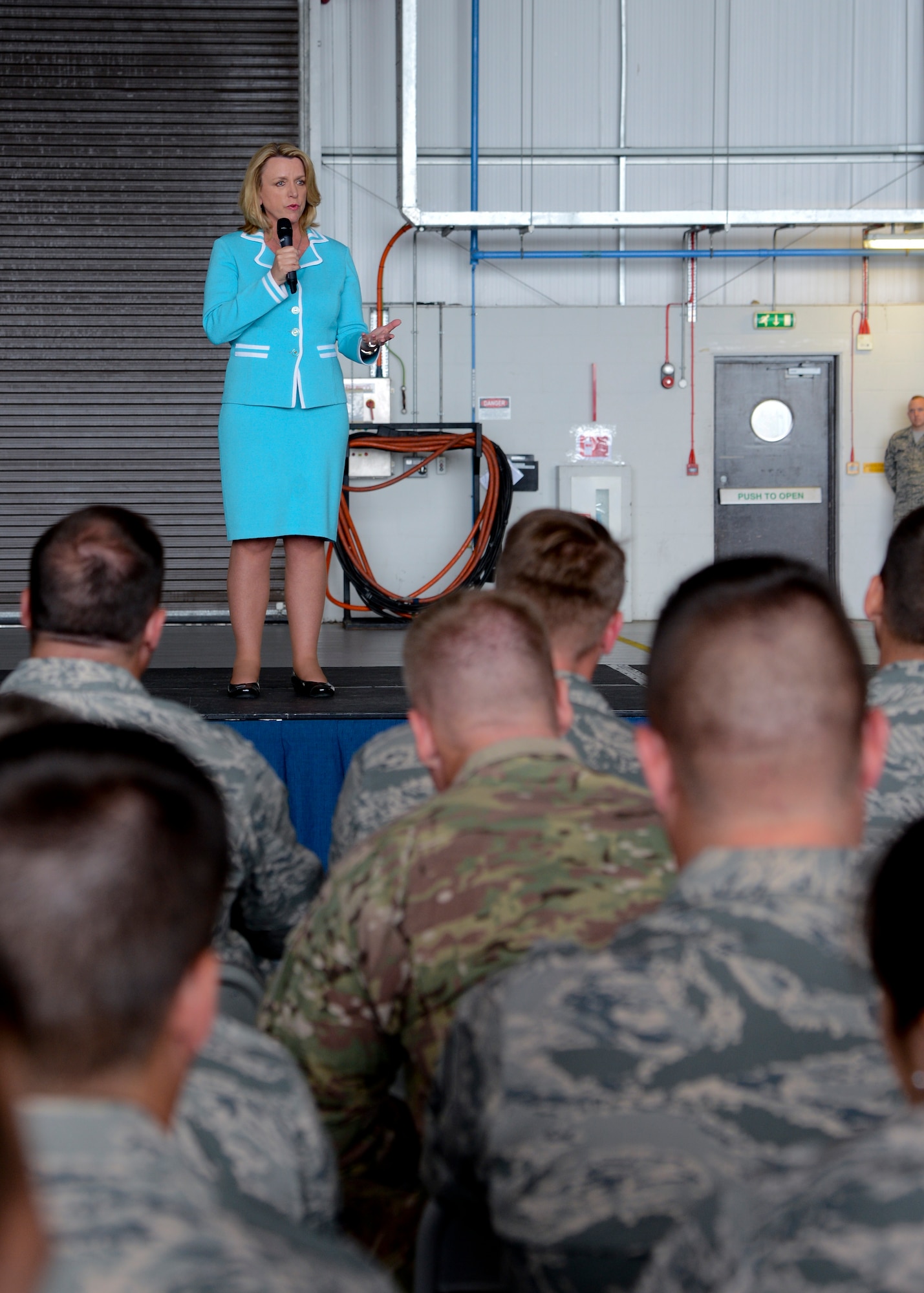 Secretary of the Air Force Deborah Lee James speaks to Airmen during an all call July 16, 2014, in Hangar 814 on RAF Mildenhall, England. James informed Team Mildenhall Airmen that her top three priorities are taking care of people, balancing the mission readiness of today with the mission readiness of tomorrow and making every dollar count. (U.S. Air Force photo/Airman 1st Class Victoria Taylor/Released)