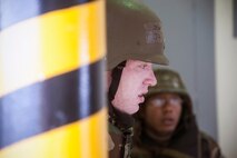 Airmen take cover under shelter from a simulated missile attack during exercise Beverly Midnight 14-2 at Kunsan Air Base, Republic of Korea, July 17, 2014. The Operational Readiness Exercise assesses mission capabilities and ensures the Wolf Pack is in a constant state of readiness. (U.S. Air Force photo by Senior Airman Taylor Curry/Released)